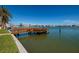 Waterfront view featuring a wooden dock extending into the tranquil bay waters at 208 Bath Club N Blvd, North Redington Beach, FL 33708