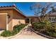 Inviting home exterior featuring a brick walkway, lush landscaping, and a warm, neutral color palette at 208 Bath Club N Blvd, North Redington Beach, FL 33708