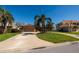 Charming single-story home with a well-maintained lawn, large driveway and mature tropical landscaping at 208 Bath Club N Blvd, North Redington Beach, FL 33708