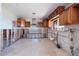 Partially renovated kitchen with water views, with custom wood cabinetry and tiled floors at 208 Bath Club N Blvd, North Redington Beach, FL 33708