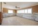 Spacious living room with ceiling fan, tile floors, and abundant natural light to be updated at 208 Bath Club N Blvd, North Redington Beach, FL 33708
