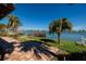 Waterfront patio features brick pavers, tropical landscaping, and a scenic view; ready to be updated at 208 Bath Club N Blvd, North Redington Beach, FL 33708
