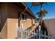 Exterior angle shot featuring a landscaped side yard, white fence, and views of the serene waterfront at 208 Bath Club N Blvd, North Redington Beach, FL 33708