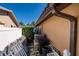 Narrow side yard view showing the home's exterior, landscaping, and maintenance considerations at 208 Bath Club N Blvd, North Redington Beach, FL 33708