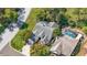 Aerial view of the home's roof, pool, surrounding greenery, and lawn at 2182 Trevor Rd, Palm Harbor, FL 34683