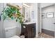 Stylish bathroom featuring a dark vanity, a green plant, and modern fixtures, creating a clean and inviting space at 2182 Trevor Rd, Palm Harbor, FL 34683