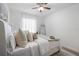 Bright bedroom featuring a bed with decorative pillows and a mirror, creating a cozy and inviting space at 2182 Trevor Rd, Palm Harbor, FL 34683