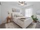 Bright bedroom featuring a comfortable bed with decorative pillows, stylish nightstands, and a ceiling fan at 2182 Trevor Rd, Palm Harbor, FL 34683
