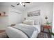Bright bedroom featuring a bed with decorative pillows, stylish nightstands, and a ceiling fan at 2182 Trevor Rd, Palm Harbor, FL 34683