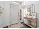 Bright entryway featuring a white door and console table with modern decor at 2182 Trevor Rd, Palm Harbor, FL 34683