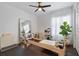 Bright exercise room features pilates machine, ceiling fan, mirror, and dark floors at 2182 Trevor Rd, Palm Harbor, FL 34683