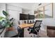 Modern home office with a spacious desk, comfortable chair, and large monitor setup, perfect for remote work at 2182 Trevor Rd, Palm Harbor, FL 34683