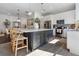 Modern kitchen with a large center island, stainless steel appliances, and custom cabinetry for ample storage space at 2182 Trevor Rd, Palm Harbor, FL 34683