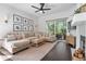 Spacious living room features a fireplace, ceiling fan, and sliding glass doors for natural light at 2182 Trevor Rd, Palm Harbor, FL 34683