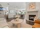 Elegant living room with fireplace, modern furniture, and an open floor plan leading to the dining and kitchen area at 2182 Trevor Rd, Palm Harbor, FL 34683