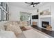 Bright living room with a cozy fireplace and sliding glass doors for seamless indoor-outdoor living at 2182 Trevor Rd, Palm Harbor, FL 34683