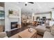 Bright, open floor plan showcasing a fireplace, dining area, and kitchen, all seamlessly connected for modern living at 2182 Trevor Rd, Palm Harbor, FL 34683