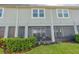 Townhouse backyard with a screened in patio and lush green space at 2507 Arbor Wind Dr, Lutz, FL 33558