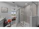 Bathroom showcasing a glass-enclosed shower and views into the bedroom area at 2507 Arbor Wind Dr, Lutz, FL 33558