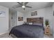 Comfortable bedroom featuring a wooden headboard, ceiling fan and neutral decor at 2507 Arbor Wind Dr, Lutz, FL 33558