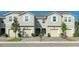 Exterior shot of townhomes showcasing garages and nicely landscaped front yards at 2507 Arbor Wind Dr, Lutz, FL 33558