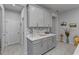 Kitchen with gray cabinets, quartz countertops, tile backsplash, and stainless fridge at 2507 Arbor Wind Dr, Lutz, FL 33558