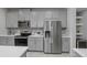 Modern kitchen with stainless steel appliances, gray cabinets and quartz countertops at 2507 Arbor Wind Dr, Lutz, FL 33558