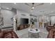 Open-concept living area with a TV, staircase, and a modern kitchen in the background at 2507 Arbor Wind Dr, Lutz, FL 33558