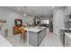 Open concept living space featuring a kitchen island, tile floors and stainless steel appliances at 2507 Arbor Wind Dr, Lutz, FL 33558
