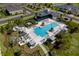 Aerial view of a stunning community pool area with cabanas and lounge chairs at 2507 Arbor Wind Dr, Lutz, FL 33558