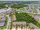 Serene aerial view of homes near a tranquil pond and lush greenery in a residential community at 28568 Tranquil Lake Cir, Wesley Chapel, FL 33543