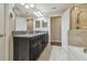 Well-lit bathroom featuring a dual sink vanity with granite countertop and a glass-enclosed shower at 28568 Tranquil Lake Cir, Wesley Chapel, FL 33543
