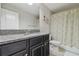 Bathroom featuring a granite countertop and decorative shower curtain at 28568 Tranquil Lake Cir, Wesley Chapel, FL 33543
