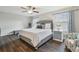 Bedroom with ample light, ceiling fan and hardwood floors at 28568 Tranquil Lake Cir, Wesley Chapel, FL 33543