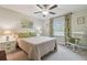 Comfortable bedroom with a ceiling fan and decorative art at 28568 Tranquil Lake Cir, Wesley Chapel, FL 33543