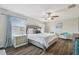 Spacious bedroom with large windows, ceiling fan, and a serene atmosphere at 28568 Tranquil Lake Cir, Wesley Chapel, FL 33543