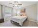 Relaxing bedroom with a window view and cozy decor at 28568 Tranquil Lake Cir, Wesley Chapel, FL 33543