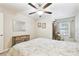 Bedroom with ceiling fan, natural light and decoratively framed pictures at 28568 Tranquil Lake Cir, Wesley Chapel, FL 33543