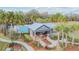 Inviting clubhouse with a pool, surrounded by lush tropical landscaping and sidewalks at 28568 Tranquil Lake Cir, Wesley Chapel, FL 33543