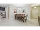 Elegant dining room featuring a chandelier, a large dining table and stainless steel refrigerator at 28568 Tranquil Lake Cir, Wesley Chapel, FL 33543