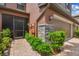 Exterior view of home with a stone pillar detail, leading to a cozy screened-in entryway at 28568 Tranquil Lake Cir, Wesley Chapel, FL 33543