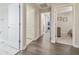Hallway with wood floors leading to bedrooms and bathroom at 28568 Tranquil Lake Cir, Wesley Chapel, FL 33543
