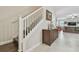 Hallway featuring a staircase, art, and seamless access to the living area at 28568 Tranquil Lake Cir, Wesley Chapel, FL 33543