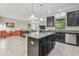 Modern kitchen with granite countertops, stainless steel appliances, and a breakfast bar at 28568 Tranquil Lake Cir, Wesley Chapel, FL 33543