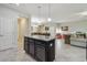 Open concept kitchen with island, pendant lighting and views into the living and dining areas at 28568 Tranquil Lake Cir, Wesley Chapel, FL 33543