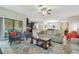 Spacious living room with neutral tones, ceiling fan, and access to the outdoor area at 28568 Tranquil Lake Cir, Wesley Chapel, FL 33543