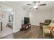 Cozy living room with hardwood floors, ceiling fan, and comfortable seating at 28568 Tranquil Lake Cir, Wesley Chapel, FL 33543
