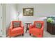 Cozy living room with coral armchairs, colorful throw pillows and aquarium feature at 28568 Tranquil Lake Cir, Wesley Chapel, FL 33543