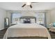 Relaxing main bedroom featuring a plush king bed and ceiling fan at 28568 Tranquil Lake Cir, Wesley Chapel, FL 33543