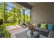 Relaxing screened patio with comfortable seating and peaceful nature views at 28568 Tranquil Lake Cir, Wesley Chapel, FL 33543